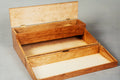 An open wooden storage box with a hinged lid and two nested compartments, made from light-colored wood with visible grain, photographed against a neutral gray background.